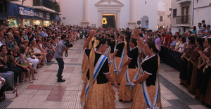 a group of people dancing in front of a crowd